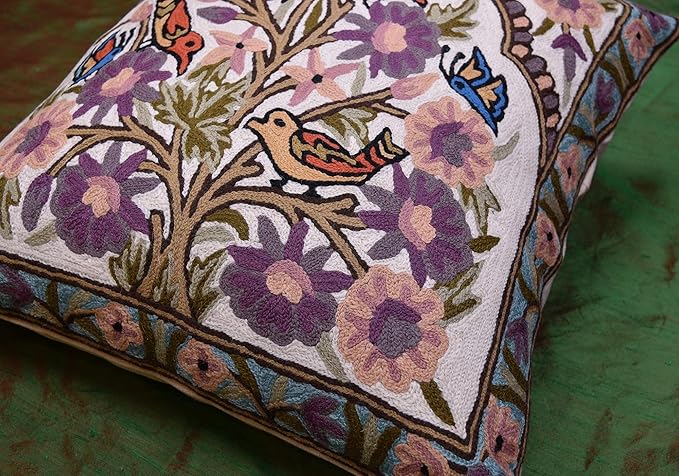 Floral bird pillow cover close-up on tree branches with purple and blue birds
