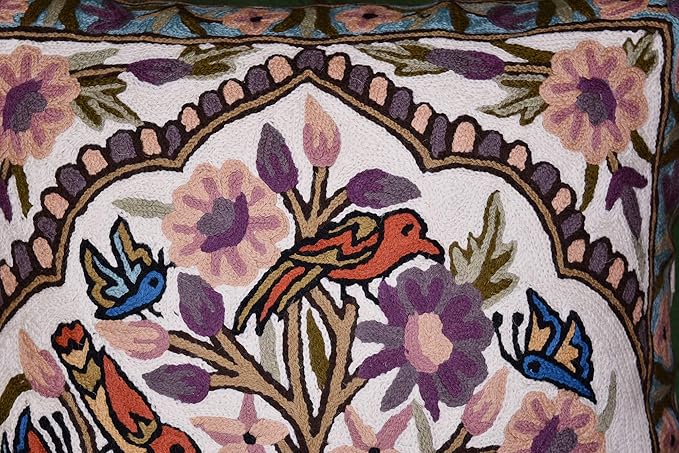 Embroidered tree of life pillow cover detail with birds, flowers, and decorative border