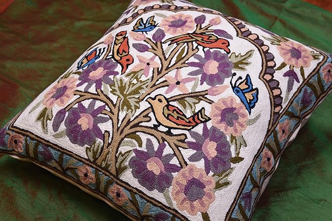 Side view of embroidered floral bird pillow cover with tree motif and purple flowers