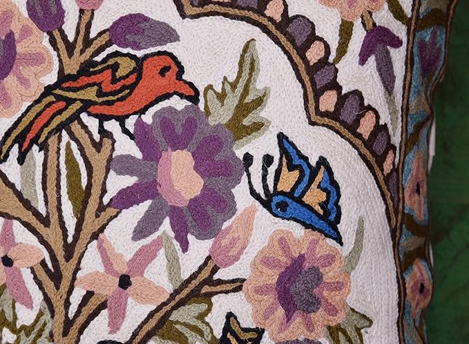 Needlepoint bird and blossom pattern on the front of a floral tree pillow cover