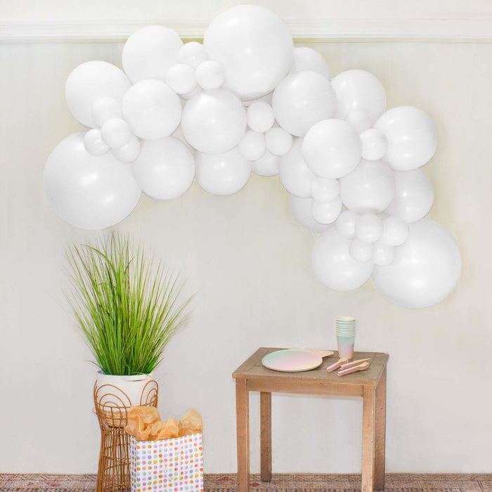 White balloon garland arch made of round white balloons clustered together