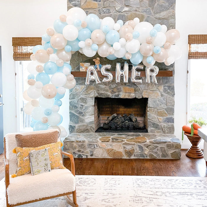 White balloon garland arch with balloon clusters in white and light blue