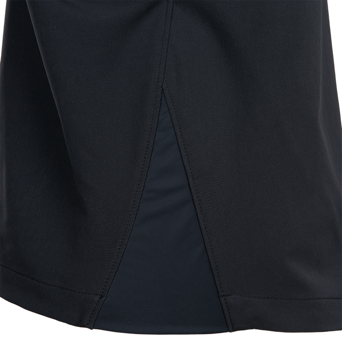 Close-up of a black fabric textile showing detailed stitching and a contrasting dark panel, possibly part of athletic apparel