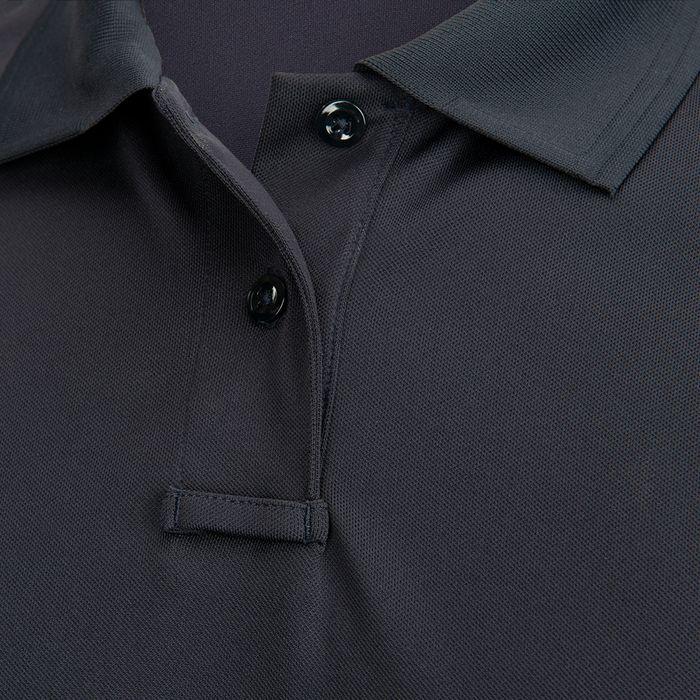 Close-up photograph of a dark gray polo shirt showing its textured fabric, three dark buttons, and a small pocket detail