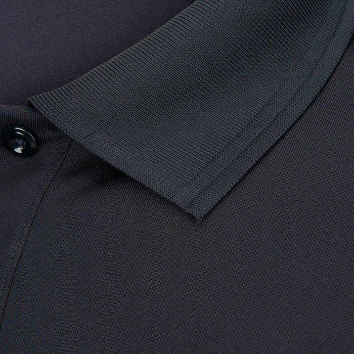 Close-up detail of a dark gray polo shirt collar showing ribbed texture a single button and fine stitching