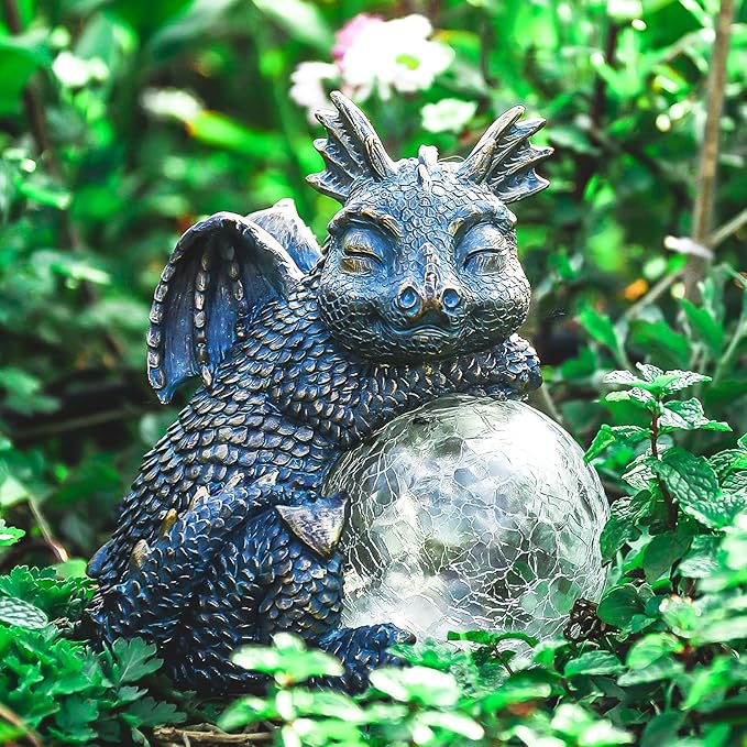 Blue dragon statue curled beside a glowing crackled glass globe solar light
